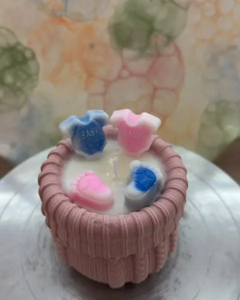 Rosa Kerzengefäß mit Babybodys und Babyfüßchen aus Wachs